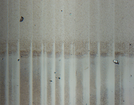 Glass delamination on a vial viewed using a stereomicroscope